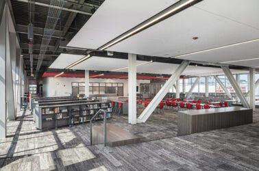 Clearwater High School Library Renovation angled perspective photo. Featuring tables in library